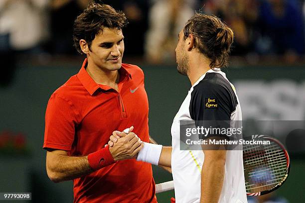 Roger Federer of Switzerland congratulates Marcos Baghdatis of Cyprus after their match during the BNP Paribas Open on March 16, 2010 at the Indian...