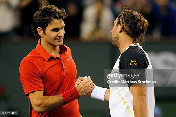Roger Federer of Switzerland congratulates Marcos Baghdatis of Cyprus after their match during the BNP Paribas Open on March 16, 2010 at the Indian...