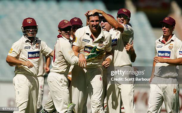 Luke Feldman of the Bulls celebrates with his team mates after dismissing Andrew McDonald of the Bushrangers during day one of the Sheffield Shield...