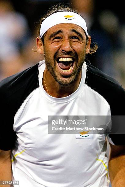Marcos Baghdatis of Cyprus celebrates match point against Roger Federer of Switzerland during the BNP Paribas Open on March 16, 2010 at the Indian...