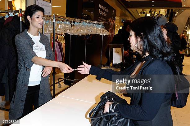 Model Michaela Schaefer works as a hostess in the cloakroom at the Peek & Cloppenburg Fashion Roadshow at Peek & Cloppenbur flagship store on March...