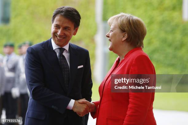 German Chancellor Angela Merkel and Italian Prime Minister Giuseppe Conte chat upon Conte's arrival at the Chancellery on June 18, 2018 in Berlin,...