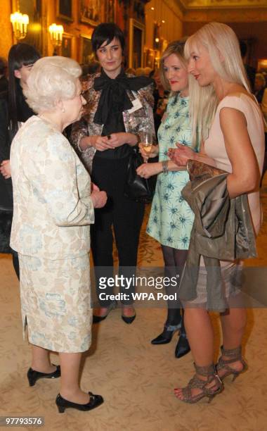 Queen Elizabeth II meets model Erin O'Connor, New Look Design Director Barbara Horspool and Brand Consultant Susanne Tide Frater at a reception for...