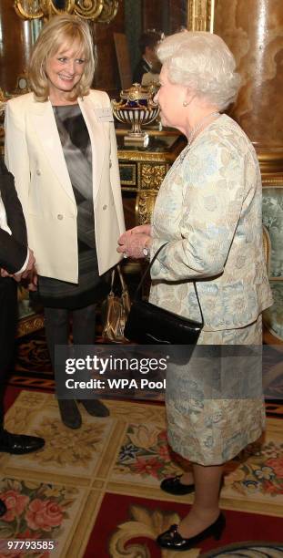 Queen Elizabeth II speaks to model Twiggy at a reception for the British Clothing Industry, including an exhibition of contemporary clothing curated...