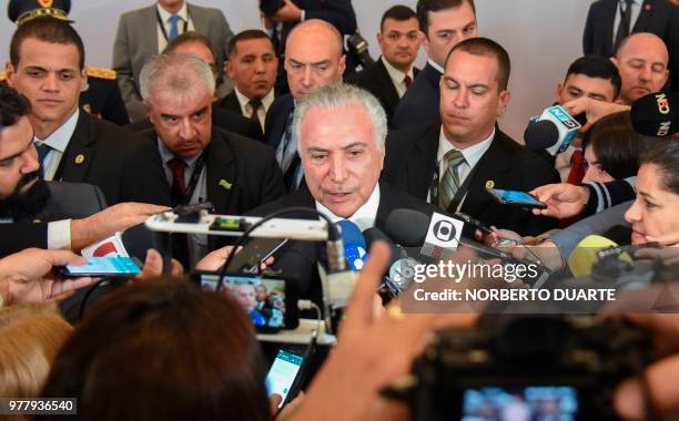 Brazil's President Michel Temer speaks with journalists after taking part in the Mercosur Summit in Luque, Paraguay, on June 18, 2018. - During the...