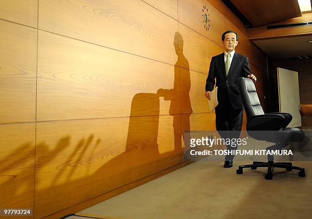 Governor Masaaki Shirakawa of the Bank of Japan takes a seat to start his annual press conference at the BOJ headquarters in Tokyo on March 17, 2010....