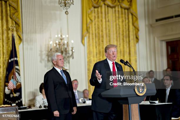 President Donald Trump, right, speaks as U.S. Vice President Mike Pence listens during a National Space Council meeting in the East Room of the White...