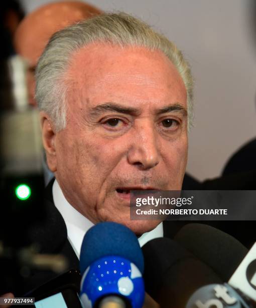 Brazil's President Michel Temer speaks to journalists after taking part in the Mercosur Summit in Luque, Paraguay, on June 18, 2018. - During the...