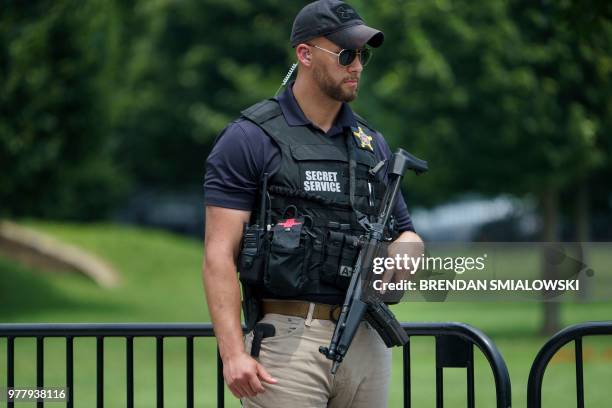 Member of the Secret Service stands guard near a road block on 17th Street near the White House on June 18, 2018 in Washington, DC.