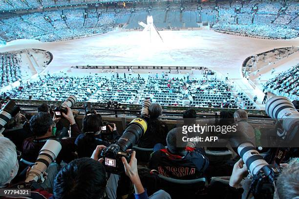 Photographers working during the Closing Ceremony in BC Stadium on February 28 during the Vancouver 2010 Olympic Winter Games. AFP PHOTO / STEPHANIE...