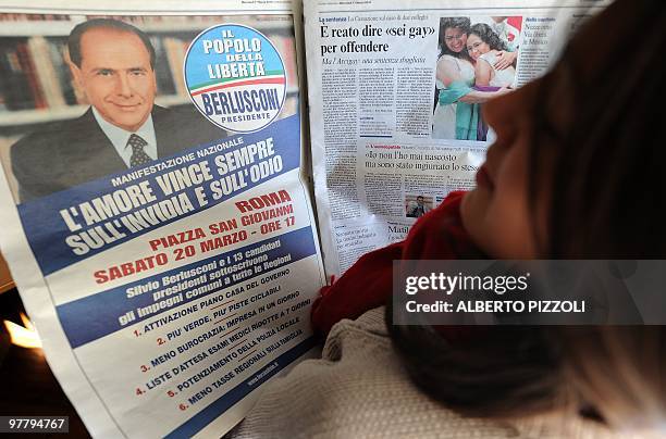 Woman reads the March 17, 2010 edition of the Italian newspaper "Corriere della Sera" with an advertisement for a demonstration of the ruling Popolo...