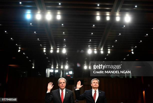 Justice Department Inspector General Michael Horowitz and FBI Director Christopher Wray take an oath before testifying to the Senate Judiciary...