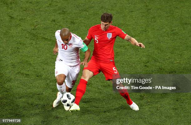 England's John Stones and Tunisia's Wahbi Khazri battle for the ball during the FIFA World Cup Group G match at The Volgograd Arena, Volgograd.