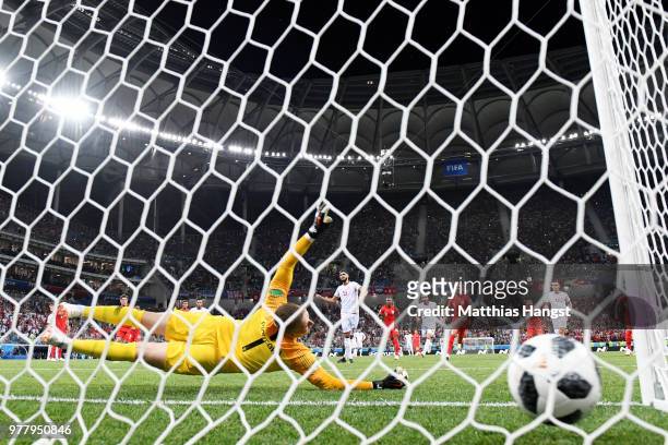 Ferjani Sassi of Tunisia scores his sides first goal from a penalty past Jordan Pickford of England to make the score 1-1 during the 2018 FIFA World...