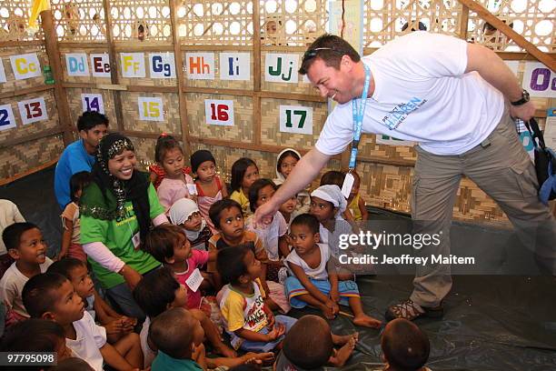 Patrick Halton of England, UNICEF Philippines Child Protection specialist, is seen with children affected by the fighting between Philippine security...