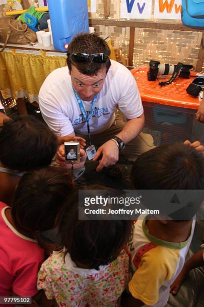 Patrick Halton of England, UNICEF Philippines Child Protection specialist, is seen with children affected by the fighting between Philippine security...
