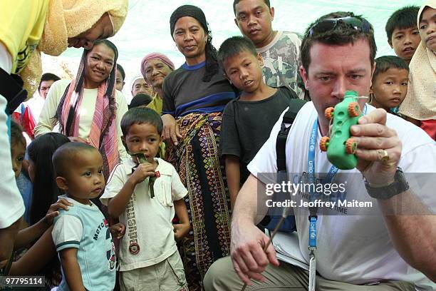 Patrick Halton of England, UNICEF Philippines Child Protection specialist, is seen with children affected by the fighting between Philippine security...