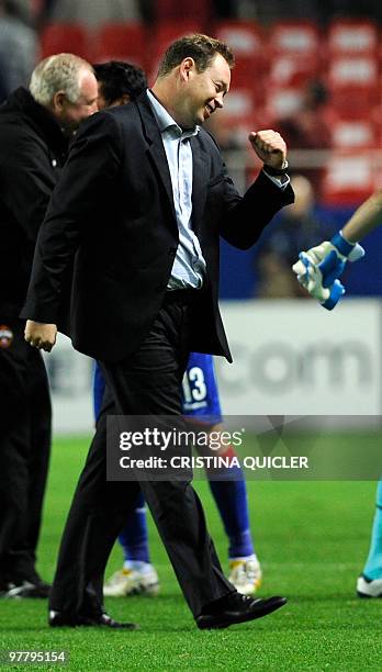 Moscow's coach Leonid Slutsky celebrates after winning a UEFA Champions League football match against Sevillaon March 16, 2010 at Ramon Sanchez...