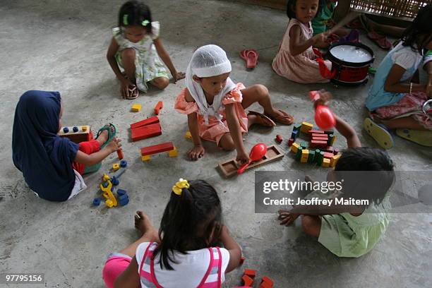 Filipino Muslim kids affected by the fighting between Philippine security forces and Muslim rebels are seen playing after undergoing psychological...
