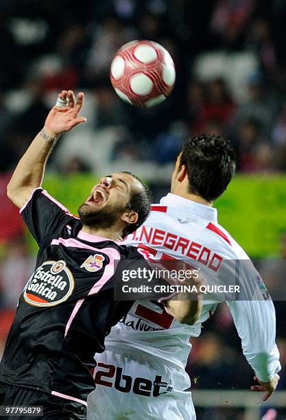 Sevilla's midfielder Álvaro Negredo vies with Deportivo Coruna's defender Alberto Lopo during a Spanish league football match at Sanchez Pizjuan...