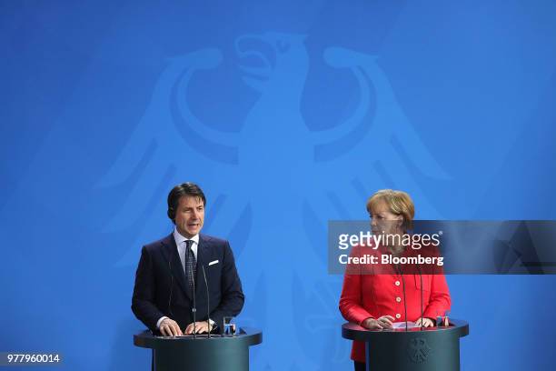 Giuseppe Conte, Italy's prime minister, left, speaks as Angela Merkel, Germany's chancellor, listens during a news conference at the Chancellery in...