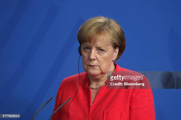 Angela Merkel, Germany's chancellor, listens during a news conference with Giuseppe Conte, Italy's prime minister, not pictured, at the Chancellery...