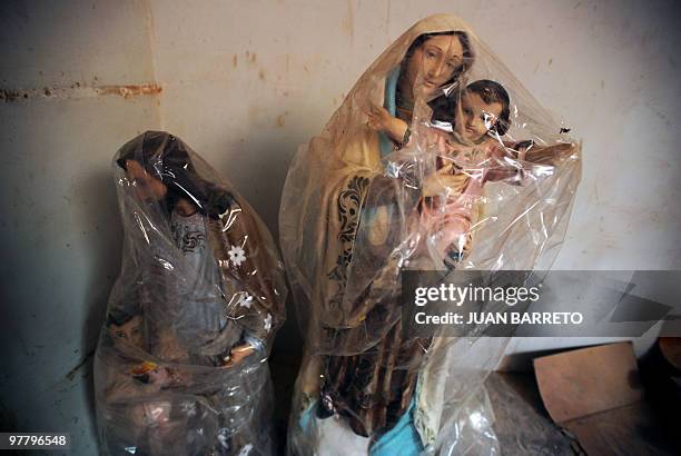 View of religious images covered with plastic bags inside an empty churh in the coastal region La Guaira, state of Vargas, 50 km from Caracas, on...