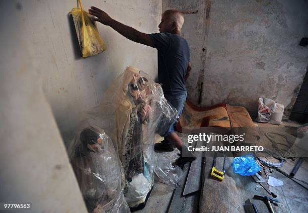 Julian Diaz a survivor of the Los Corales area, in the coastal region La Guaira, state of Vargas, 50 km from Caracas, takes some belongings from...