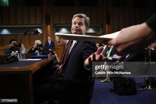 Federal Bureau of Investigation Director Christopher Wray recieves notes from an aide prior to testifimony before the Senate Judiciary Committee on...