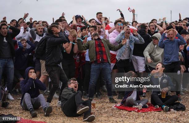 Football fans react as England go close to scoring as they watch the match inside the Lunar Beach Cinema on Brighton beach as England play Tunisia in...