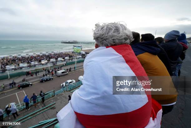 Football fans watch the match from the promenade as England play Tunisia in the group stages of the 2018 FIFA World Cup tournament on June 18, 2018...