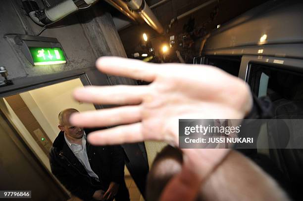 Hand covers the camera while a photographer tries to shoot pictures of injured and operated British AC Milan footballer David Beckham as he is...