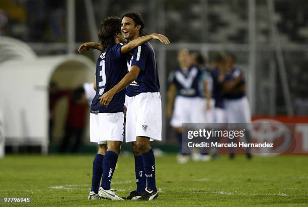 Argentina's Velez Sarfield Emilinao Papa and Fabian Cubero celebrate a goal against Chile's Colo Colo during their match as part of the 2010...