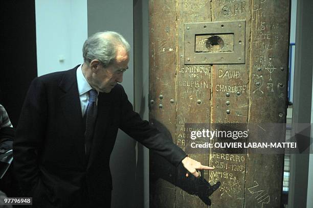 French former President of the Constitutional council, socialist Robert Badinter, looks at an ancient cell's door during the inauguration of the...