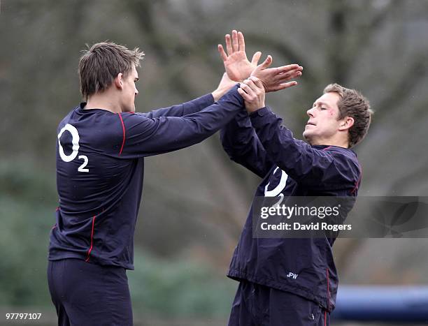 Jonny Wilkinson playfully fights with team mate Tobby Flood in a warm up session during the England training session held at Pennyhill Park on March...