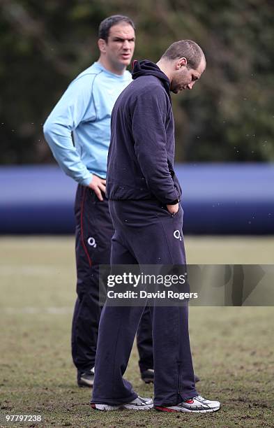 Steve Borthwick, the injured England captain looks concerned as team manager Martin Johnson looks on during the England training session held at...