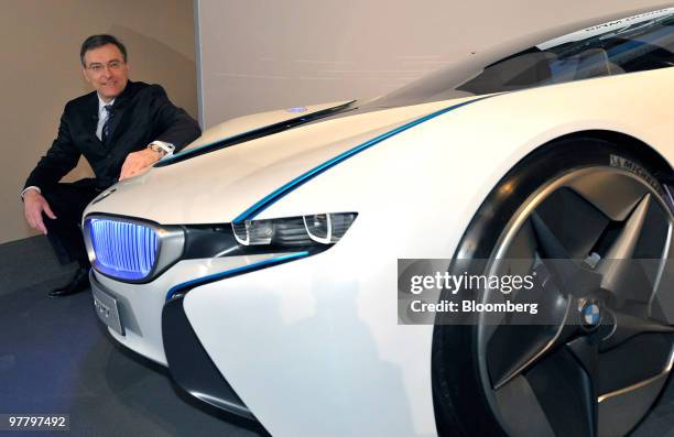 Norbert Reithofer, chief executive officer of Bayerischen Motoren Werke AG , poses in front of a BMW Vision concept car during the company's news...