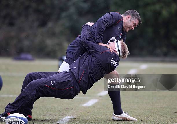 Dan Cole, the England prop, is held by team mate Nick Easter during the England training session held at Pennyhill Park on March 17, 2010 in Bagshot,...