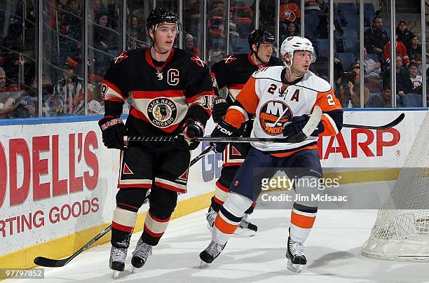 Jonathan Toews of the Chicago Blackhawks skates against Mark Streit of the New York Islanders on March 2, 2010 at Nassau Coliseum in Uniondale, New...