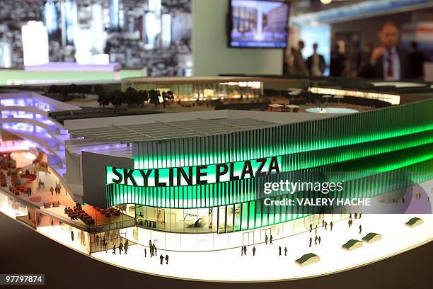 People look at a scale model of Skyline Plaza architectural project in Franfurt at a stand during the 21st edition of the international MIPIM...