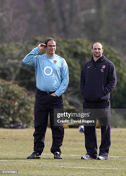 Steve Borthwick, the injured England captain looks concerned as team manager Martin Johnson looks on during the England training session held at...