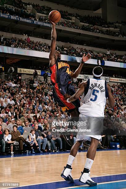 Anthony Tolliver of the Golden State Warriors shoots against Josh Howard of the Dallas Mavericks during the game at the American Airlines Center on...
