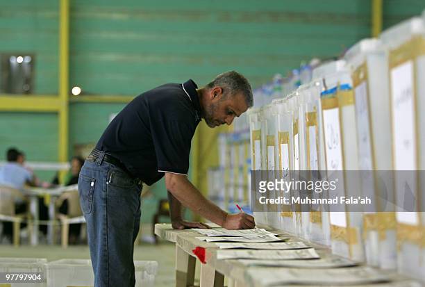 An Iraqi electoral worker works near ballot boxes of Iraq�s Parliamentary elections on March 17, 2010 at a counting center in Baghdad, Iraq. 79...