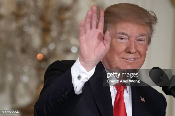 President Donald Trump waves during a meeting of the National Space Council at the East Room of the White House June 18, 2018 in Washington, DC....