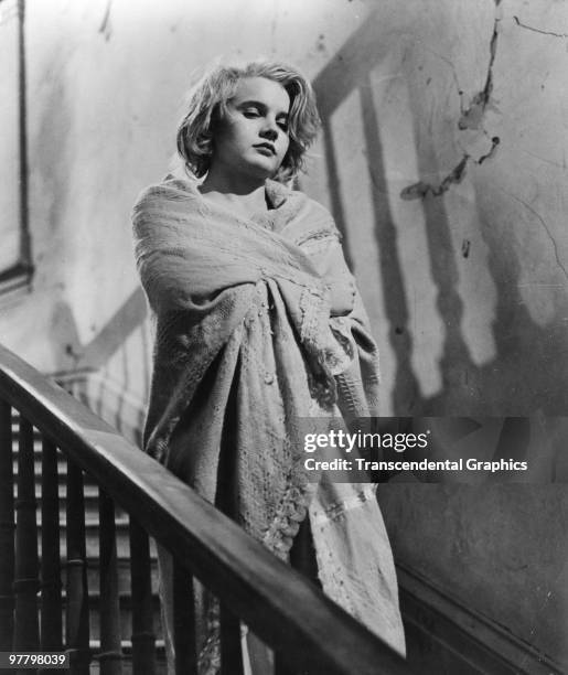 Film still of American actress Carroll Baker, as she stands on a staircase wrapped in a blanket in a scene from 'Baby Doll' , 1956.