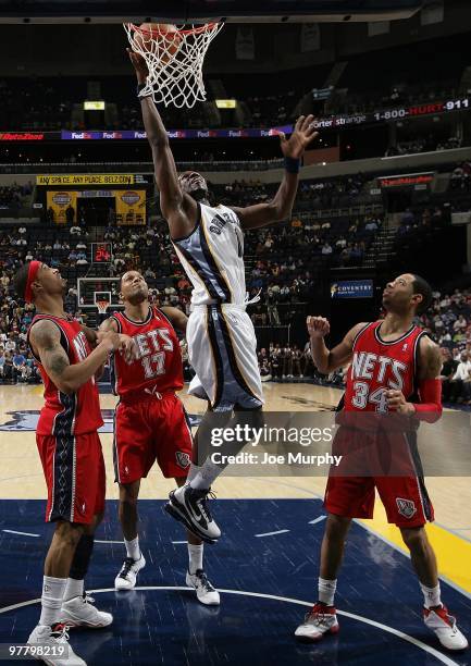 DeMarre Carroll of the Memphis Grizzlies goes to the basket against Courtney Lee, Chris Douglas-Roberts and Devin Harris of the New Jersey Nets...