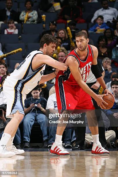 Brook Lopez of the New Jersey Nets handles the ball against Marc Gasol of the Memphis Grizzlies during the game on March 8, 2010 at FedExForum in...