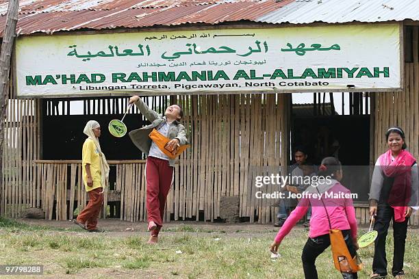 Filipino Muslim teenagers affected by the fighting between Philippine security forces and Muslim rebels are seen playing after undergoing...