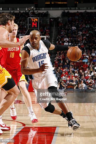 Vince Carter of the Orlando Magic drives to the basket against David Andersen and Chase Budinger of the Houston Rockets during the game at Toyota...