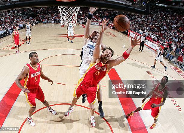 David Andersen of the Houston Rockets rebounds against Marcin Gortat of the Orlando Magic during the game at Toyota Center on February 24, 2010 in...